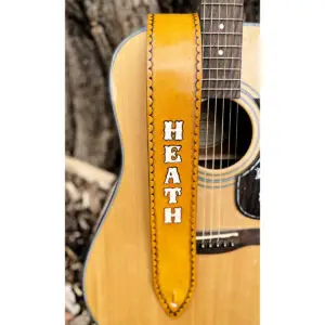 Tan Personalized Leather Guitar Strap with White letter placed vertically down the front of the strap