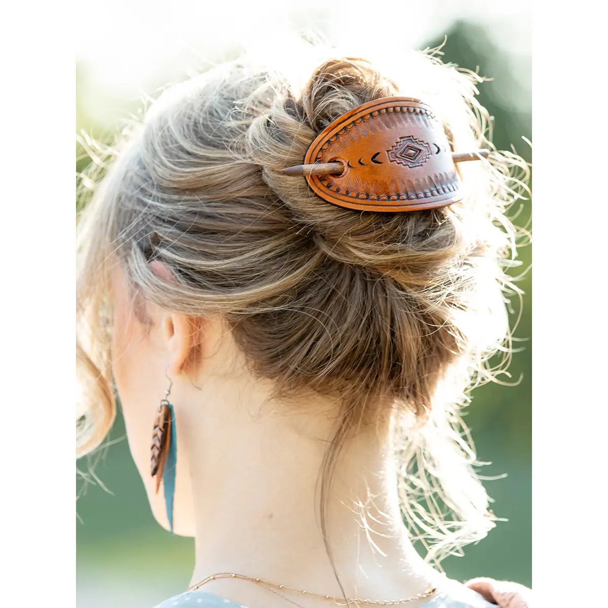 Model wearing tan tooled leather hair slide